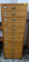 A hardwood filing cabinet of twelve drawers with brass handles on stile feet 164cm x 57cm x 66cm