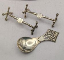 A pair of silver knife rests together with a silver tea caddy spoon hallmarked London 1936, total