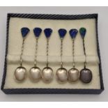 Seven white metal spoons stamped 940 having lapis lazuli terminals and one other, 39.3g Location: