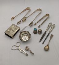 Mixed silver to include three pairs of sugar tongs and others along with a pair of white metal sugar