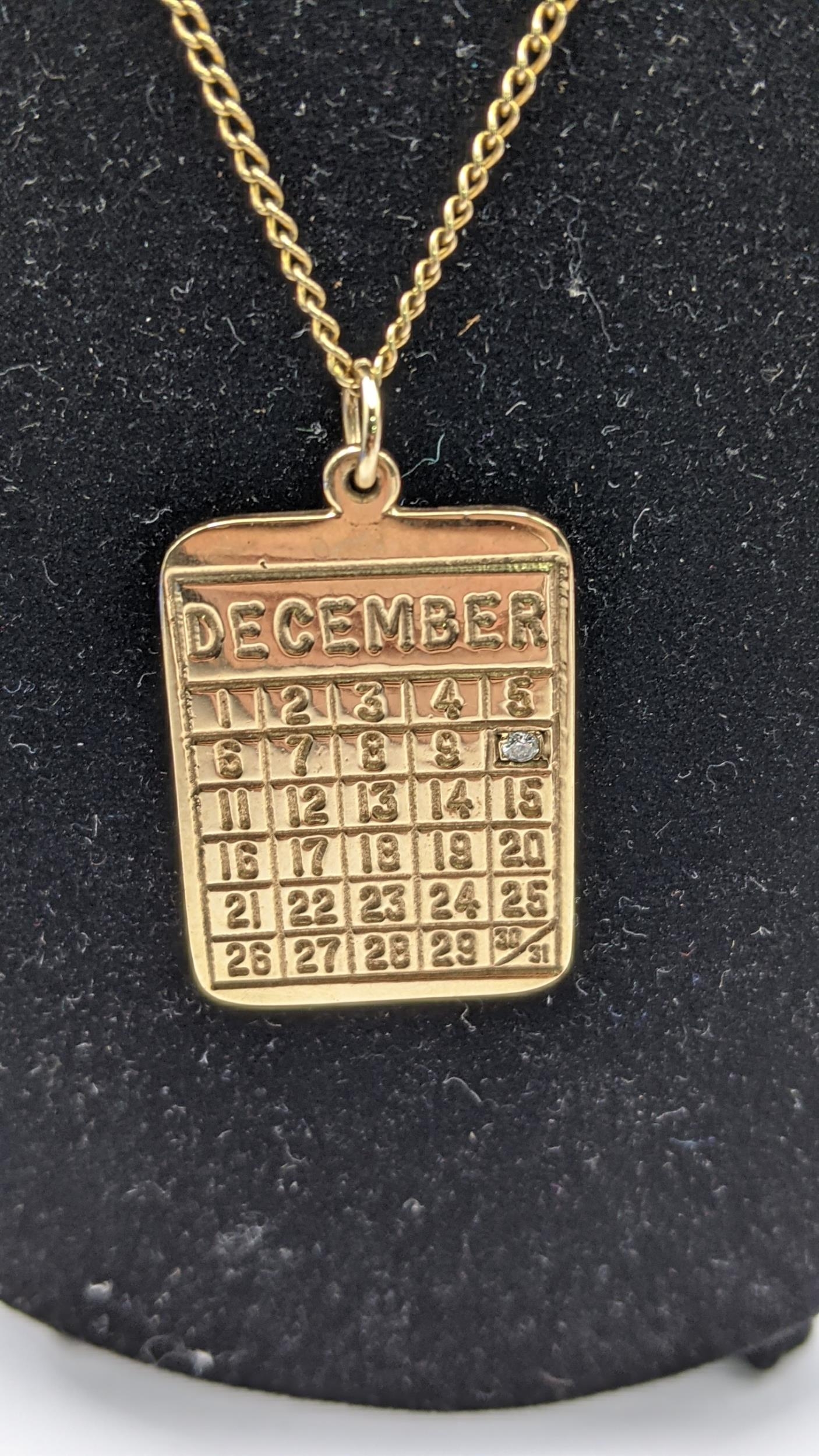 A 9ct gold calendar pendant set with a diamond on a 9ct gold necklace total weight 9.5g Location: - Image 2 of 2