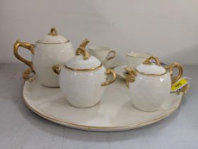 A late 19th/early 20th century Limoges cabaret set comprising a tray, teapot, sugar bowl, milk jug