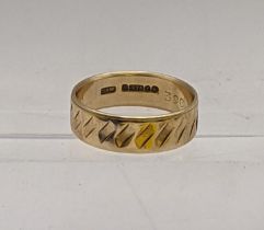 A 9ct gold band having engraved detail, total weight 3.3g Location: