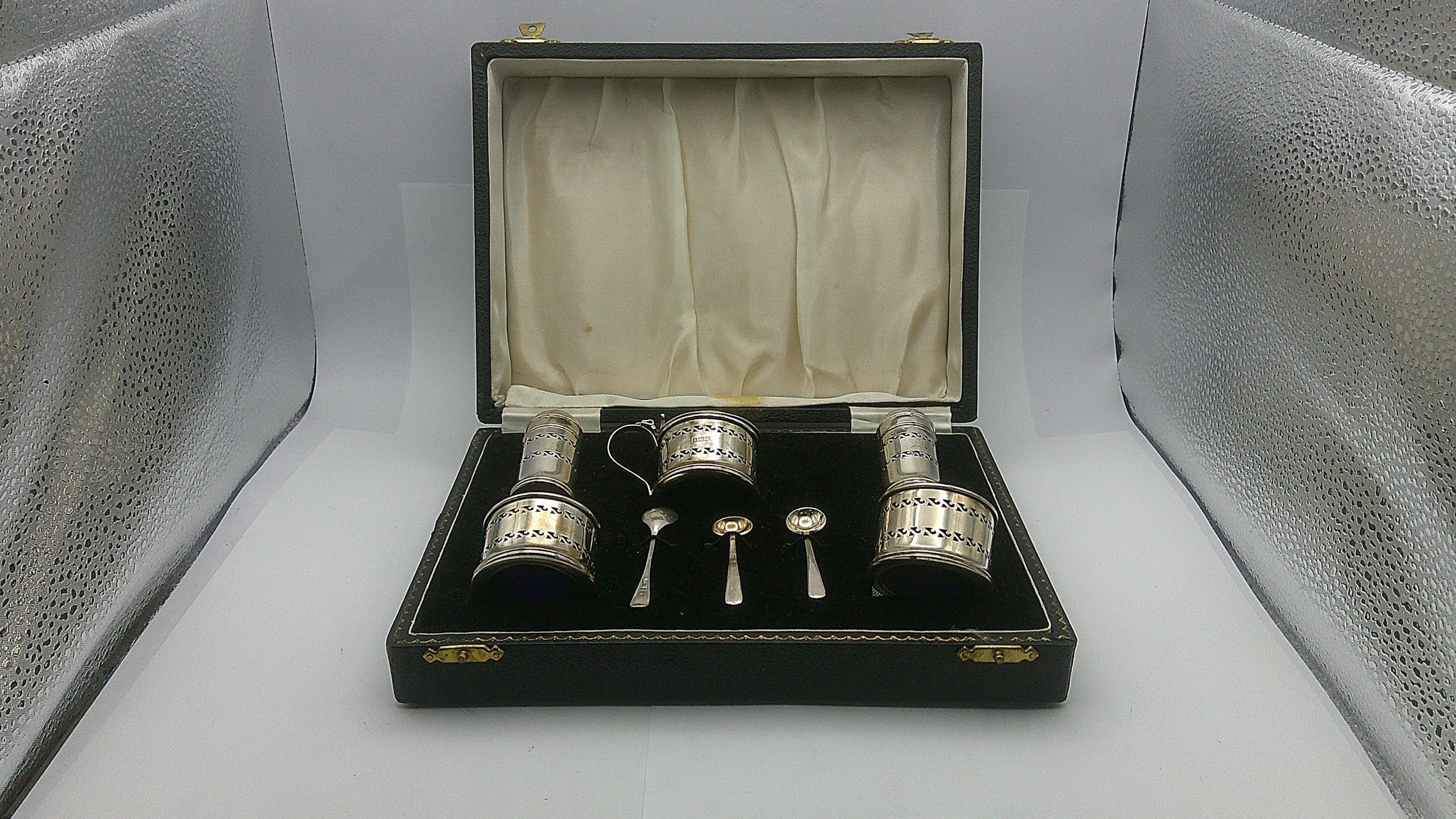 A set of silver condiment set with three silver spoons, cased. 70.6g Location: