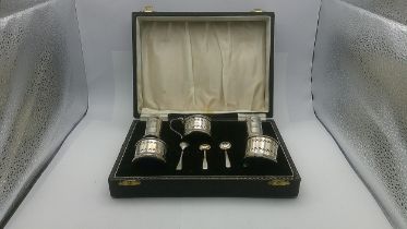 A set of silver condiment set with three silver spoons, cased. 70.6g Location: