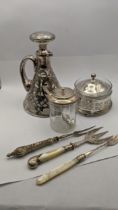 Silver and white metal to include a silver lidded jar and spoon, a floral white metal overlaid