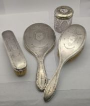 Silver backed dressing table items to include a brush, mirror, a dressing table jar and one other
