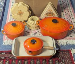 A collection of Le Creuset casserole dish, lidded pot, saucepan, roasting pan together with jelly