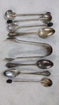 Mixed silver to include sugar tongs, coffee bean spoons, and teaspoons, 86.6g Location:
