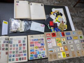 Stamps and other collectables to include three stamp albums with stamps around the world including