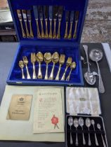 A Bestecke Solingen chrome nickel steel cutlery set with gilt handles, cased set of four Edwardian