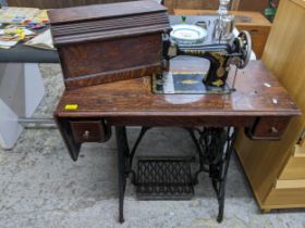 An iron framed and oak cased trestle Singer sewing machine serial number F3950503 Location: