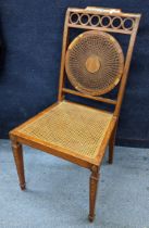 An Edwardian satinwood Sheraton Revival side chair having Adams style decoration, having a caned