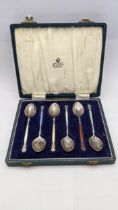 A boxed set of six silver an enamel Asprey coffee spoons hallmarked Birmingham 1964 total weight