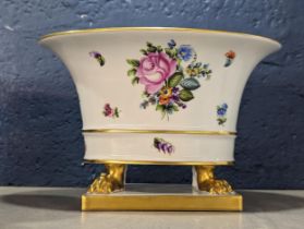 A Herend porcelain jardiniere having floral painted decoration on four lion paw feet and rectangular