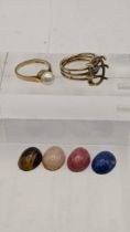 A 9ct gold ring with four interchangeable stones, and a 9ct gold ring set with a pearl, total weight