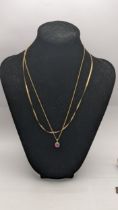 A 9ct gold herringbone necklace together with a 9ct gold pendant set with a sapphire and paste