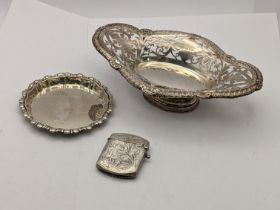 Mixed silver to include a pierced one footed dish, a silver pin tray along with a floral embossed