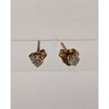 A pair of 9ct gold diamond stud earrings Location: