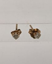 A pair of 9ct gold diamond stud earrings Location:
