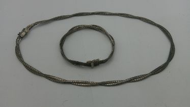 A Silver necklace and a matching bracelet 39.5g Location: