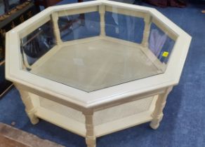 A reproduction octagonal two tier coffee table with a glass top Location: RAB