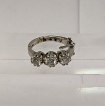 A platinum three stone diamond ring having a hinged shank, total weight 6.7g Location: