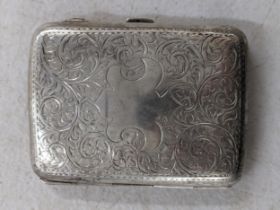 An early 20th century silver cigarette case engraved with scrolls and a cartouche, 65.7g Location: