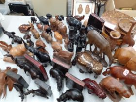 A quantity of African treen carved models of animals together with book ends and other treen