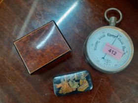 An early 20th century barometer in the style of a goliath pocket watch, a walnut box and an ebonized