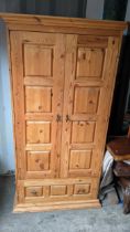 A modern pine two door wardrobe with drawer below, 180.5 x 93.5cm Location: