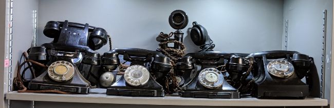 A collection of vintage telephones including five vintage Bakelite telephones, one wall hanging