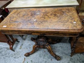 An early Victorian walnut pedestal card table, swivel and fold over top with circular inset baize,