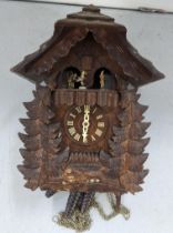 A German black forest carved cuckoo clock with Goebel inset figures Location: