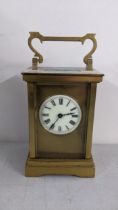 A late 19th century brass carriage clock having platform lever escapement enamel dial with Roman