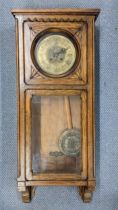 An early 20th century oak cased 8-day wall hanging clock striking on a gong, 93.5cm h x 39cm w,