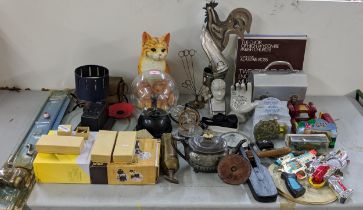A mixed lot to include a model cat, a plasma ball, an Avominor, a china model of a hand and head,