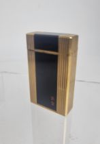 A Dupont lighter with a black lacquered and gold plated case Location: