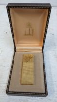 A Dunhill gold plated cigarette lighter with diamond cut decoration boxed Location: