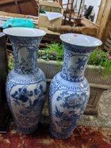 Two floor standing late 20th century Oriental porcelain vases, each decorated with reserves of birds