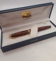 A 1993 Caran d'Ache fountain pen having a brown burr walnut effect body with 18ct gold plated collar