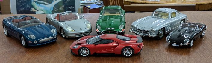 Six model cars to include a Maisto Porche Boxter and Jaguar XK180 a Birago 1961 Jaguar E type and