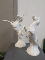 Attributed to Michael Sutty, two porcelain unicorns modelled in rearing pose in a blanc de chine