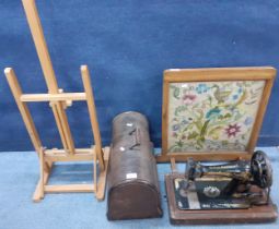 A Singer sewing machine in domed oak case, an oak framed tapestry fire screen, a pine easel