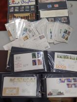 A quantity of First Day covers and mint definitive stamps in five albums to include loose