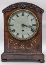 A Regency mahogany bracket clock, the arched top case carved with scrolls, motif to the centre,