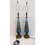 A pair of mid 20th century America blue glass and gilt table lamps on brass bases, rewired and PAT