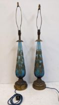 A pair of mid 20th century America blue glass and gilt table lamps on brass bases, rewired and PAT