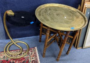 A North African occasional table with a brass tray top, folding legs and an occasional table