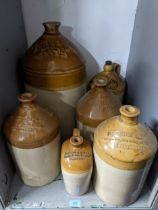 A Group of stoneware bottles advertising local breweries and business to include Nicholson & sons